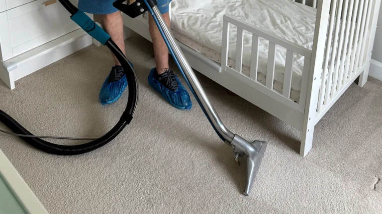 A professional worker using a rug cleaner to restore a carpet, making it spotless and fresh.