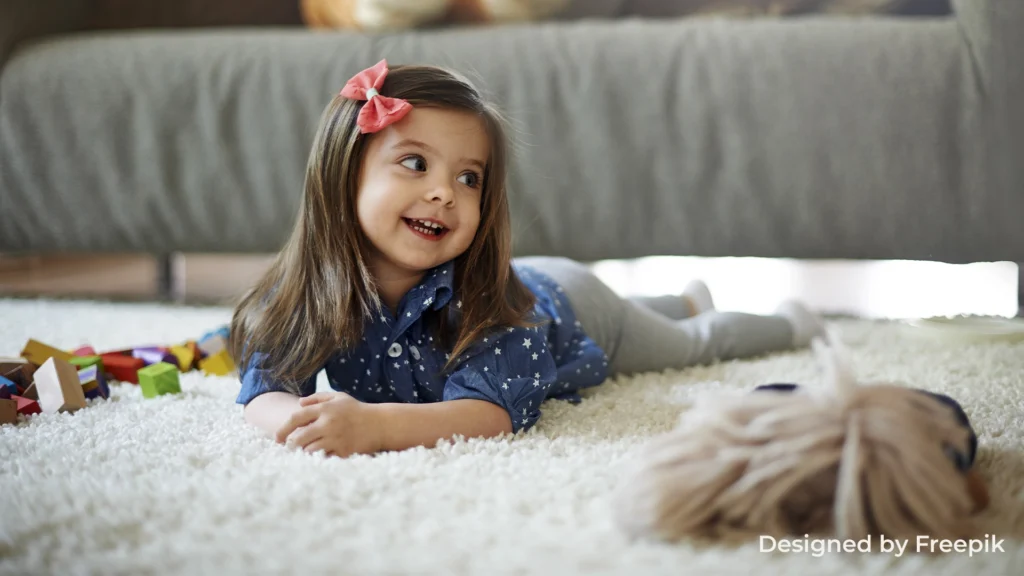 Smiling girl playing and lying on a clean, fresh carpet, enjoying the comfort it brings to the home.
